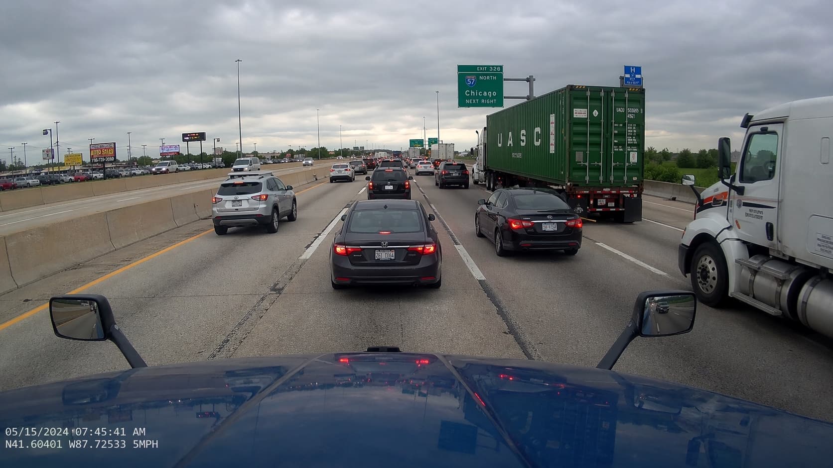 Dashcam view of Chicago highway traffic with a semi-truck in the right lane